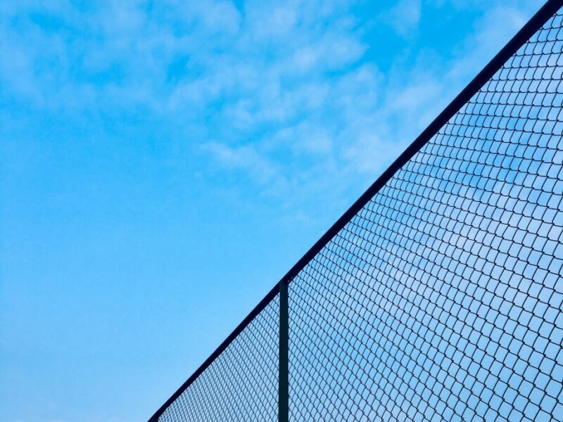 chain-link fence under blue sky during daytime