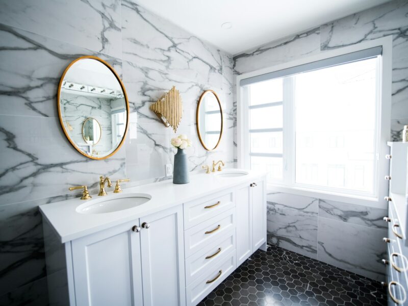a bathroom with two sinks and a large mirror