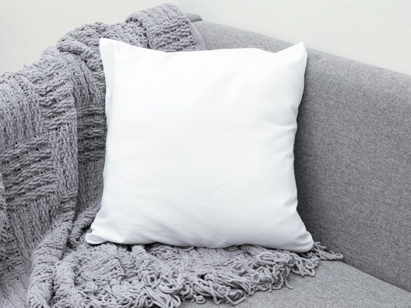 white throw pillow on gray sofa