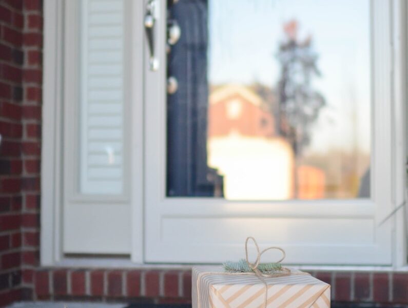 four brown gift boxes near white door