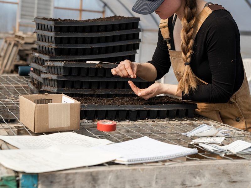 woman in black long sleeve shirt holding black pen