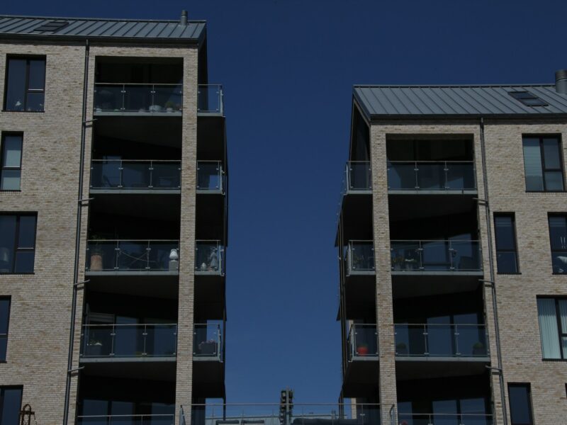 two tall brick buildings with balconies and balconies