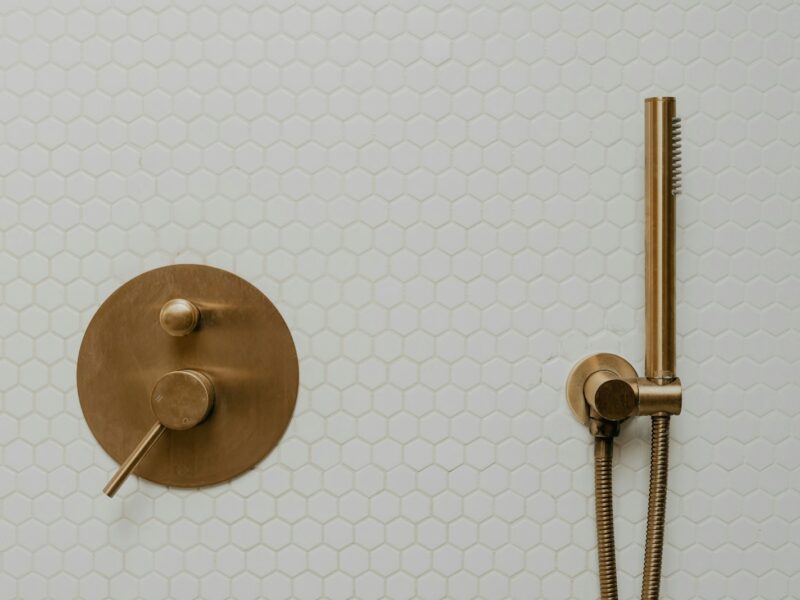 a shower head and shower faucet in a bathroom