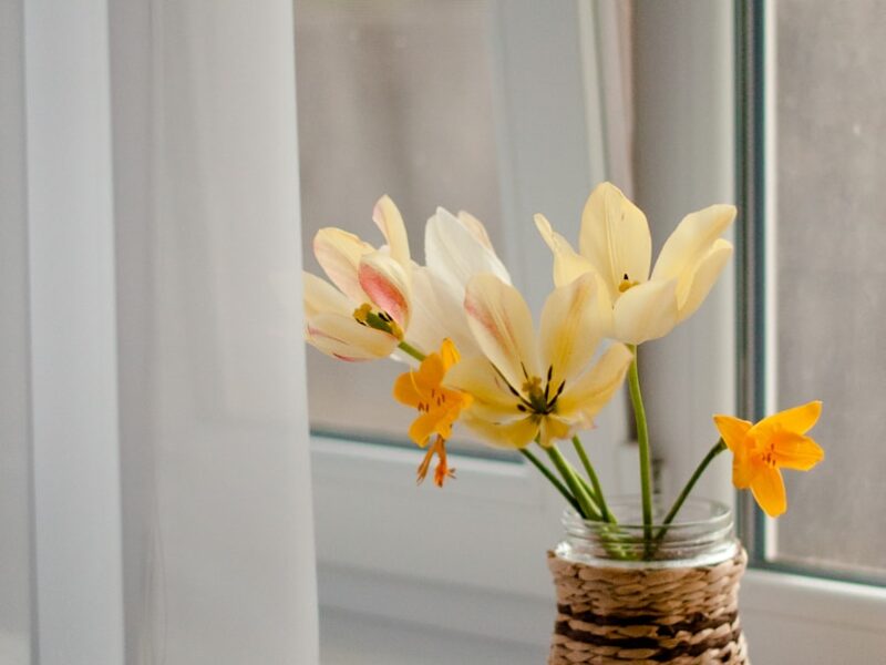 yellow and white flowers in brown woven basket