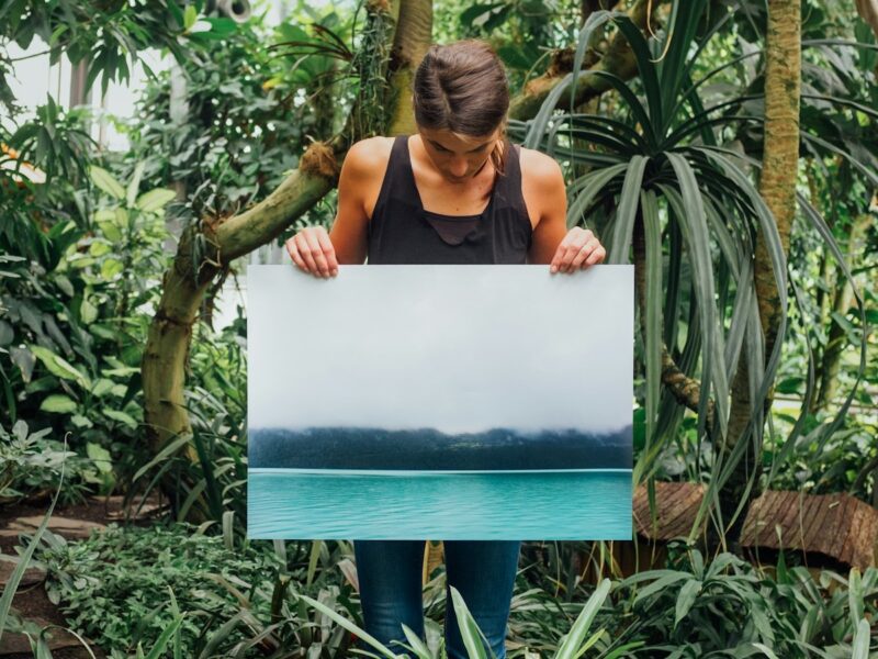 woman holding photo of tidal wave