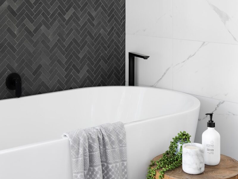 white bathtub near white ceramic bathtub