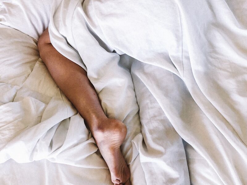 woman covered with white blanket