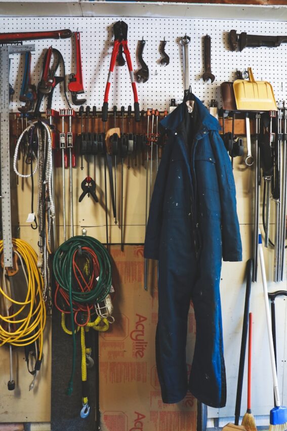black leather jacket hanging on brown wooden drawer