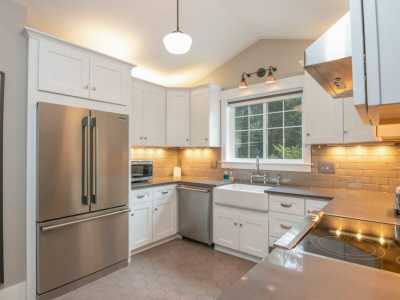 white wooden kitchen cabinet and white pendant lamp