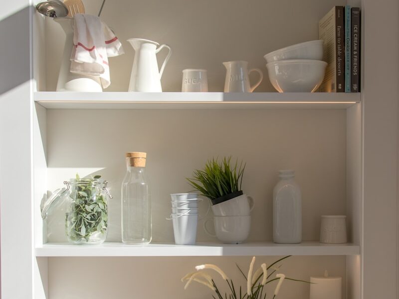 bowls and bottles in white wooden 4-layer shelf