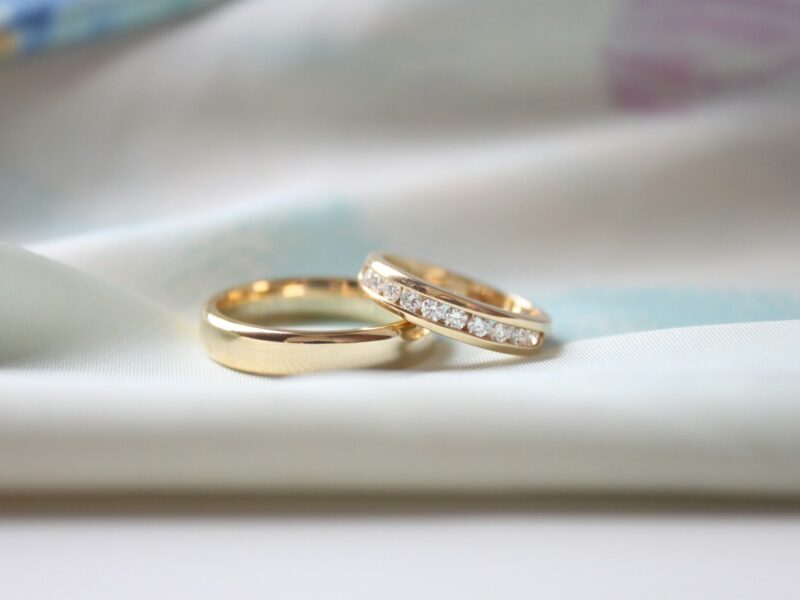 two wedding rings sitting on top of a white cloth