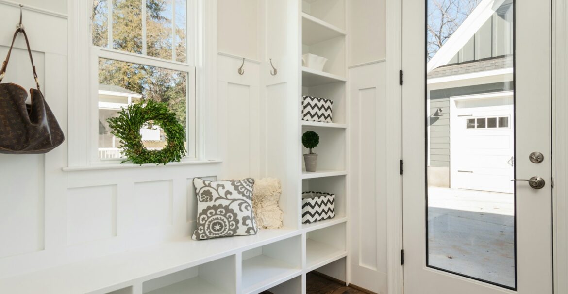 gray and white floral throw pillow beside rack inside room