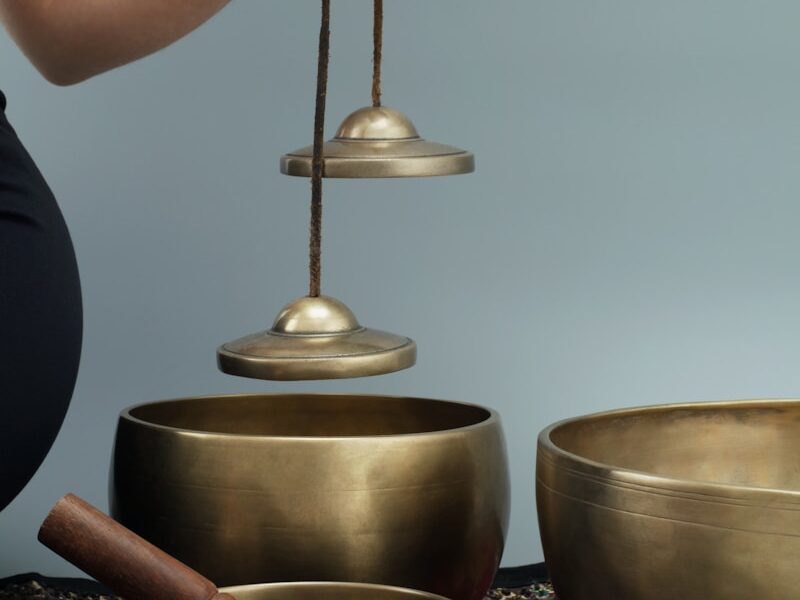 person holding brown wooden round container