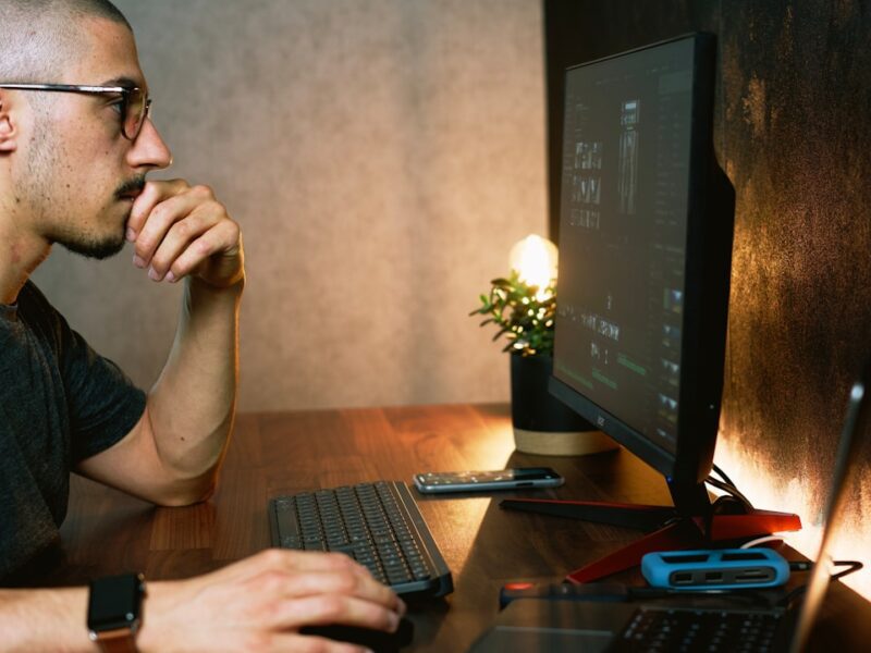 man in gray crew neck t-shirt using computer