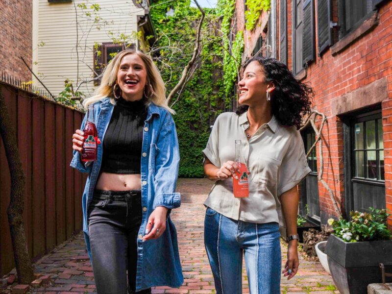 woman in blue denim jacket standing beside woman in white shirt