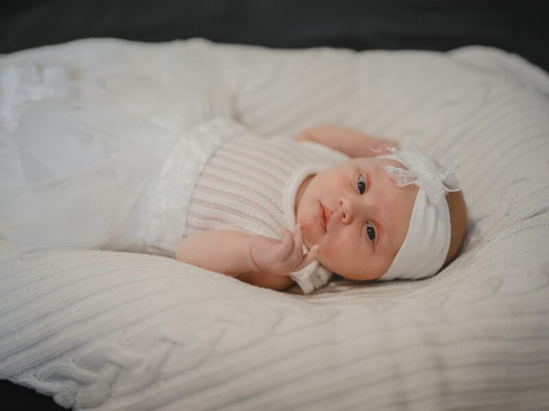 a baby lying on a bed