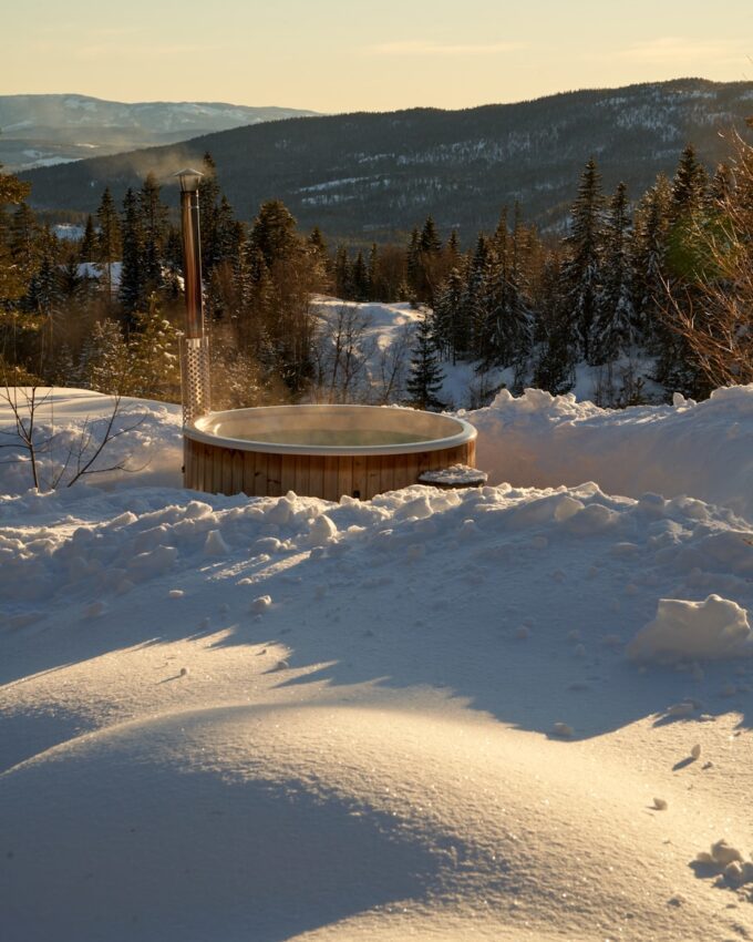 a hot tub in the middle of a snowy field