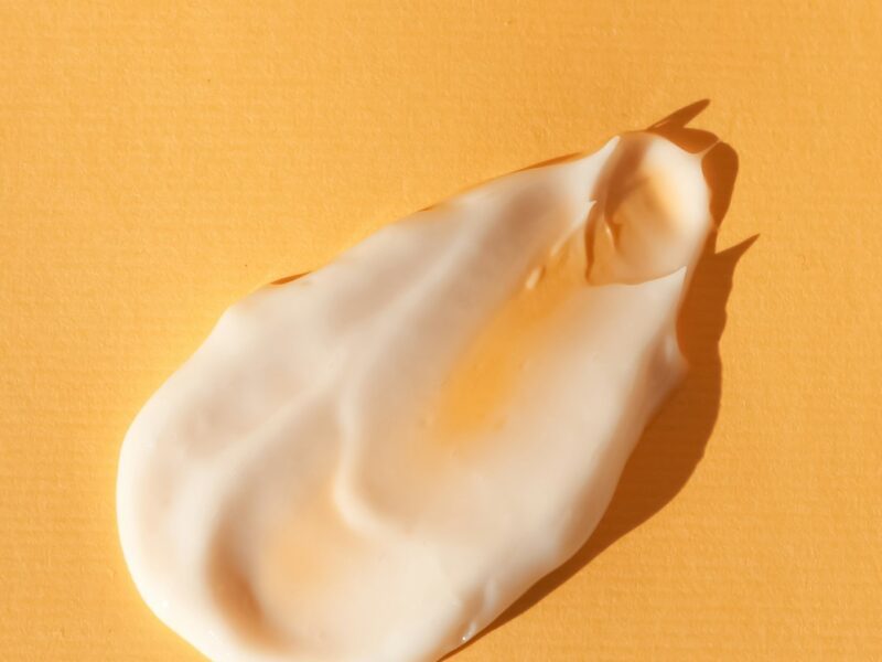 a close up of a white substance on a yellow surface