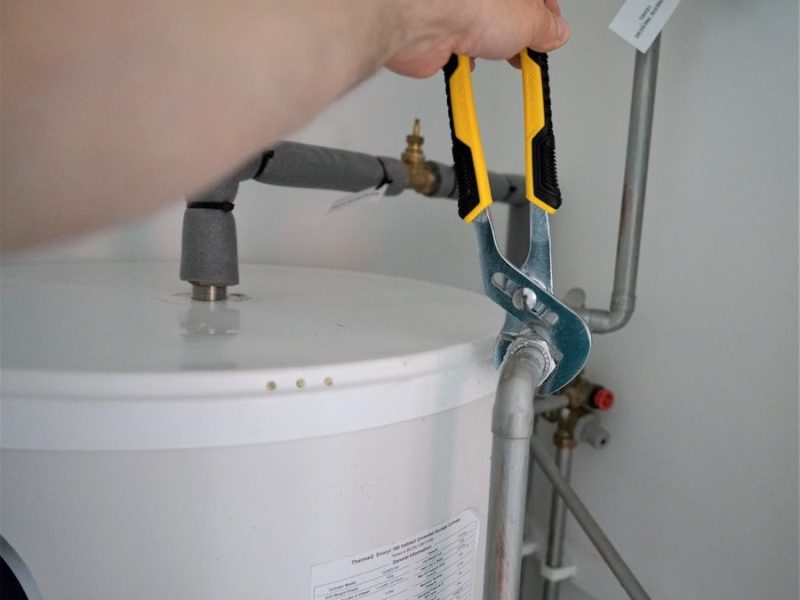 person holding yellow and gray hand tool