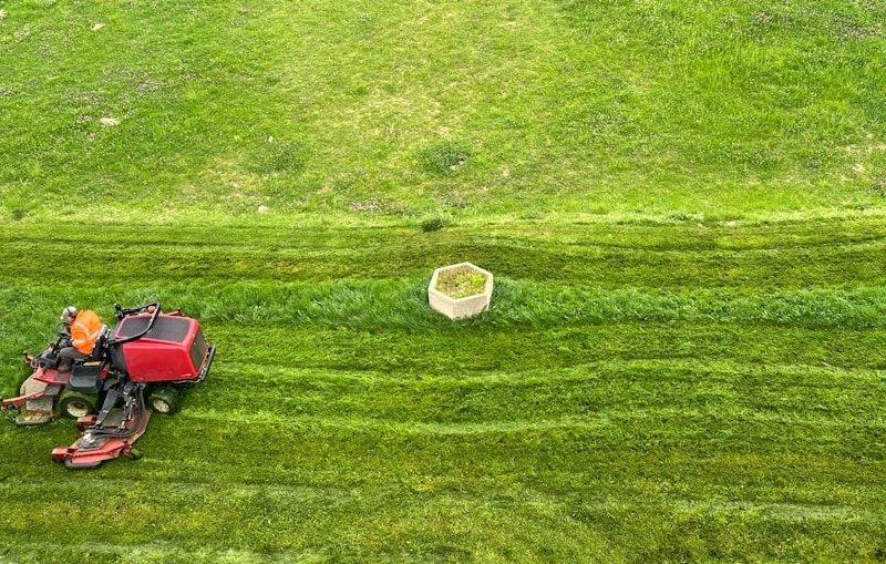 a tractor is parked in the middle of a green field