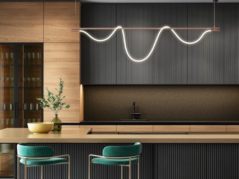 a modern kitchen with a bar and stools