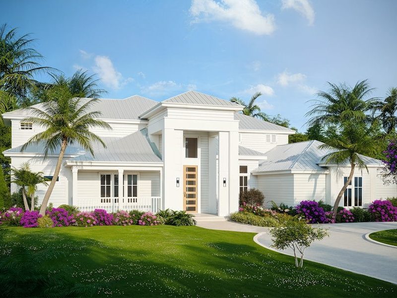 A modern white house with lush landscaping