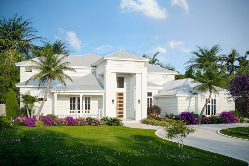 A modern white house with lush landscaping