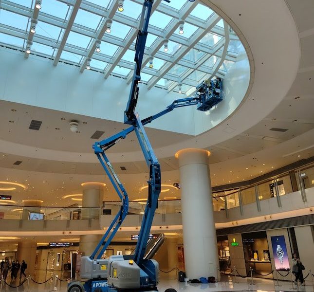 a man on a scissor in a large building