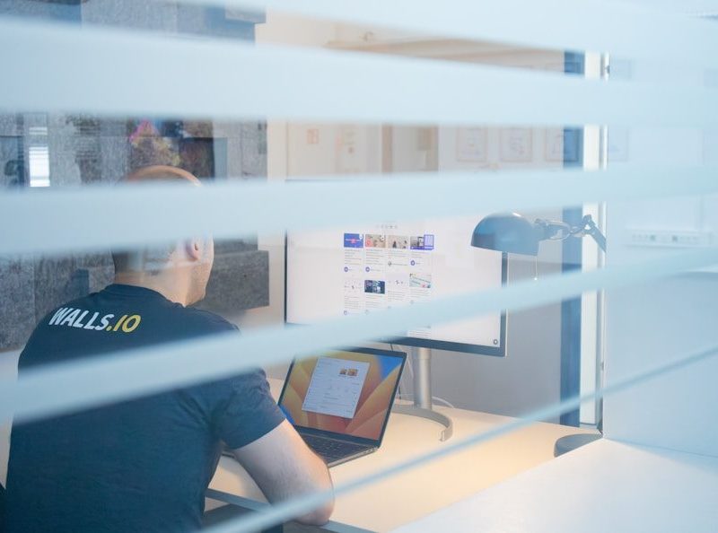 a man sitting at a desk in front of a computer