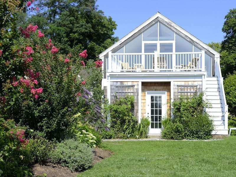 A white house with a porch and a deck
