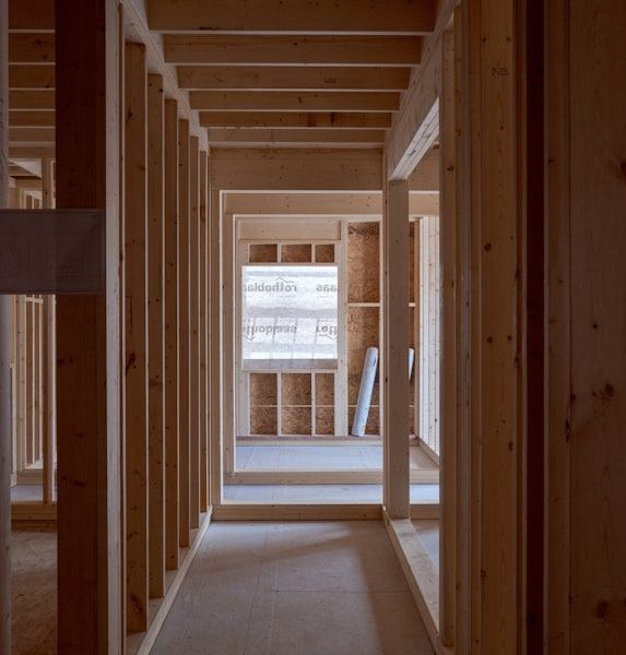 an empty room with wooden walls and beams