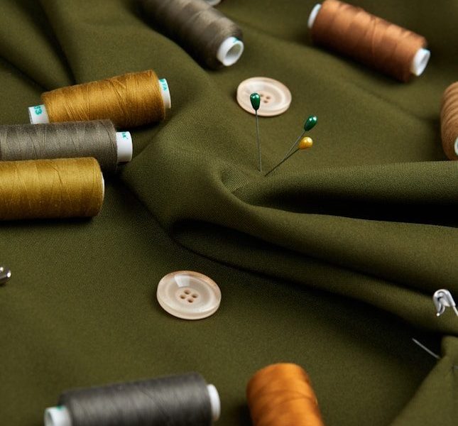 a table topped with lots of different colored spools of thread