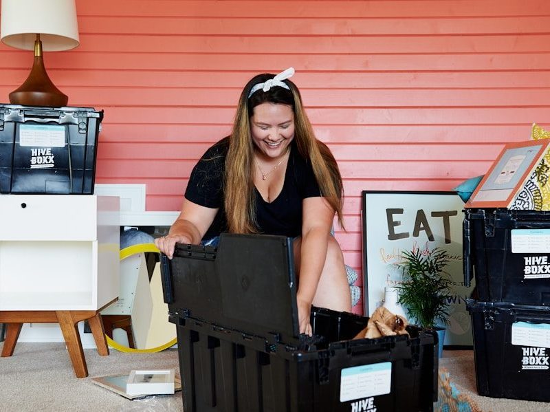woman in black tank top sitting on black plastic crate