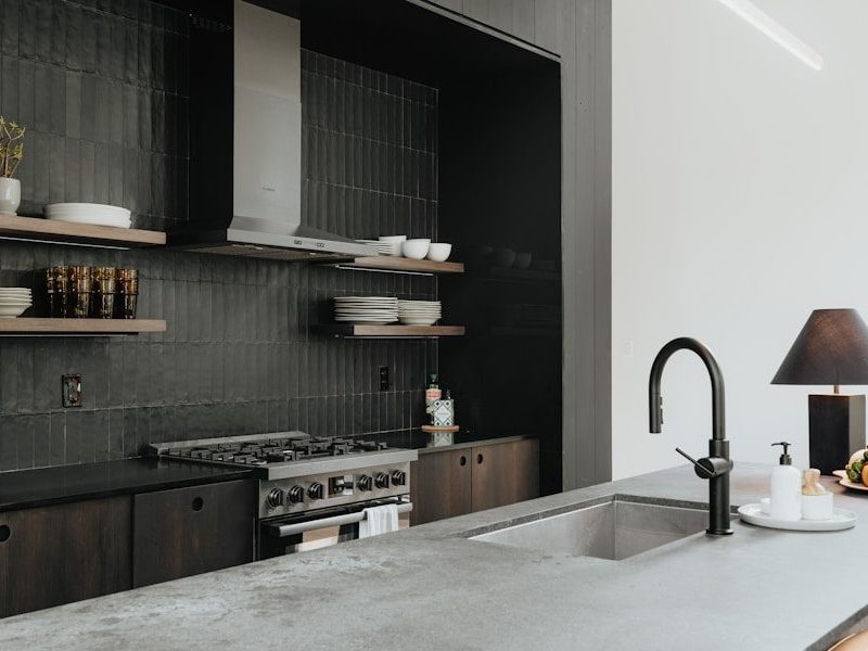 a kitchen with a sink and a stove top oven