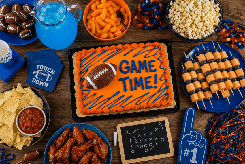 Football-themed party with snacks and decorative cake.