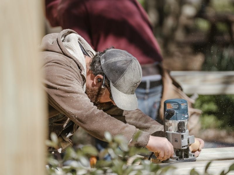 a man using a driller on a piece of wood