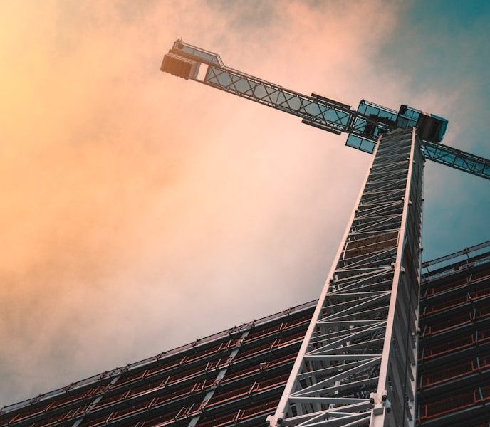 low angle photography of gray tower crane