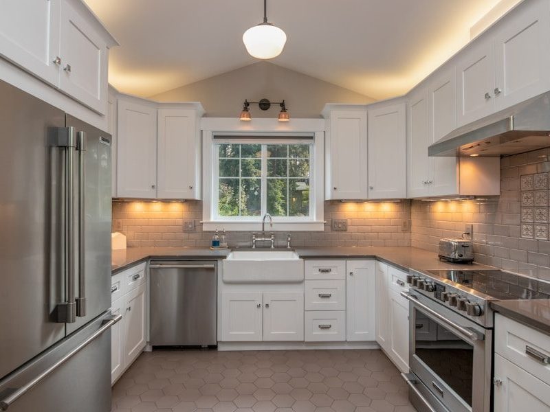 white wooden kitchen cabinet with white pendant lamp