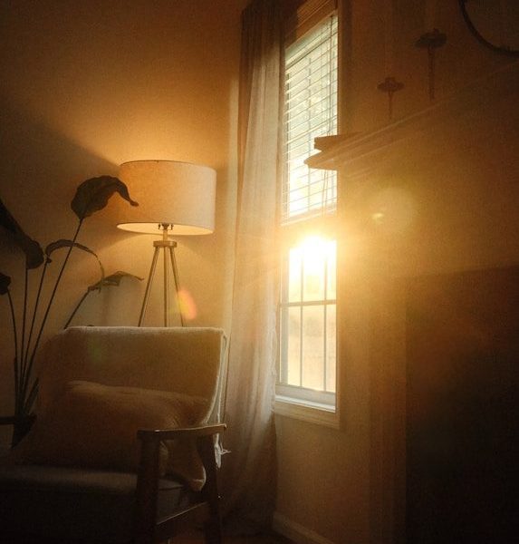 Sunlight streams through a window into a cozy room.