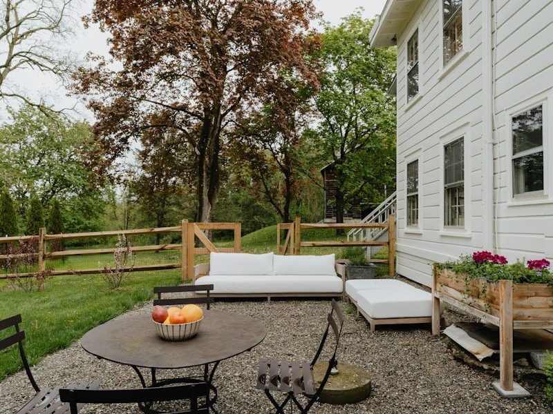 a patio with a table and chairs and a couch