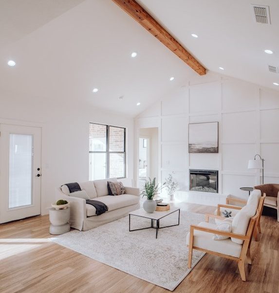 a living room with a couch a chair and a fireplace