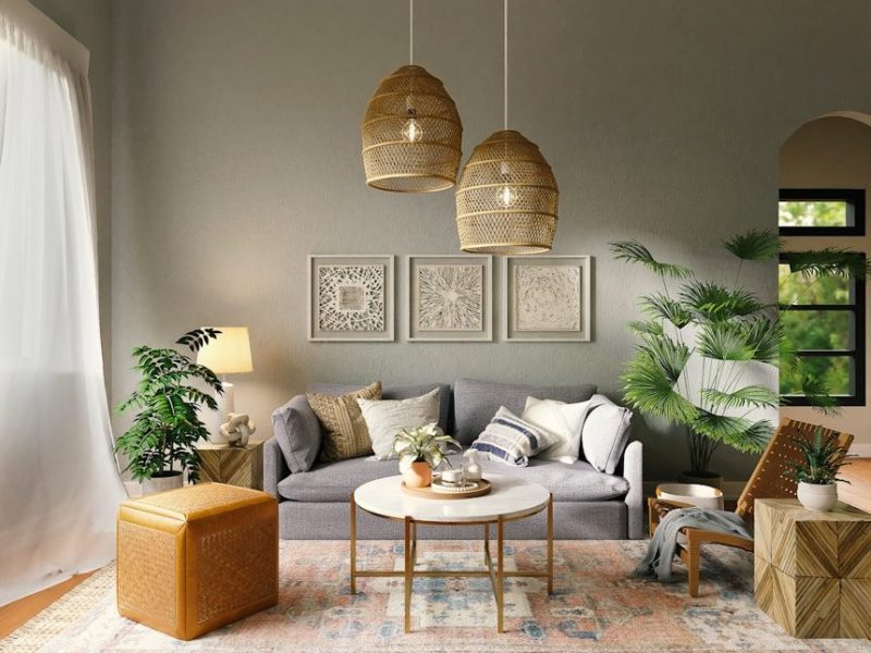 A grey sofa with patterned pillows in a living room with woven pendant lights