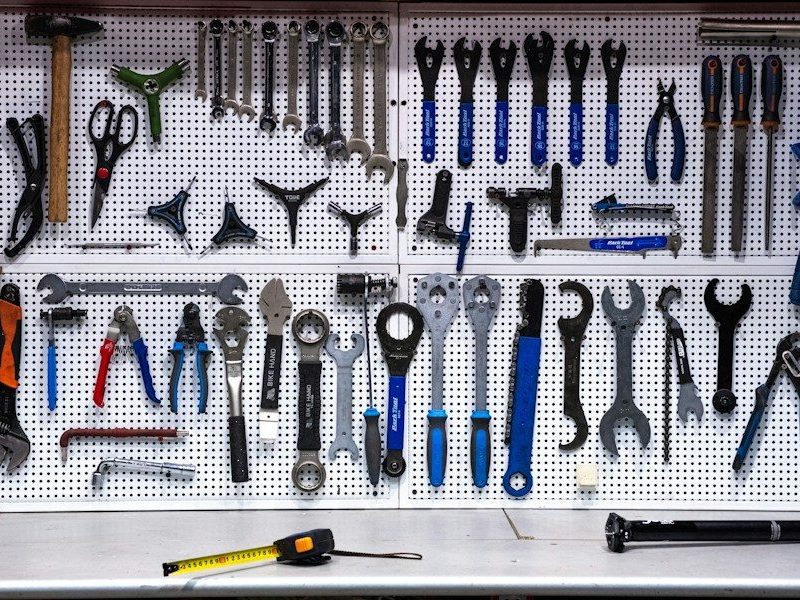 a bunch of tools hanging up on a wall