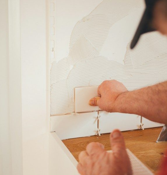 person pressing white wall