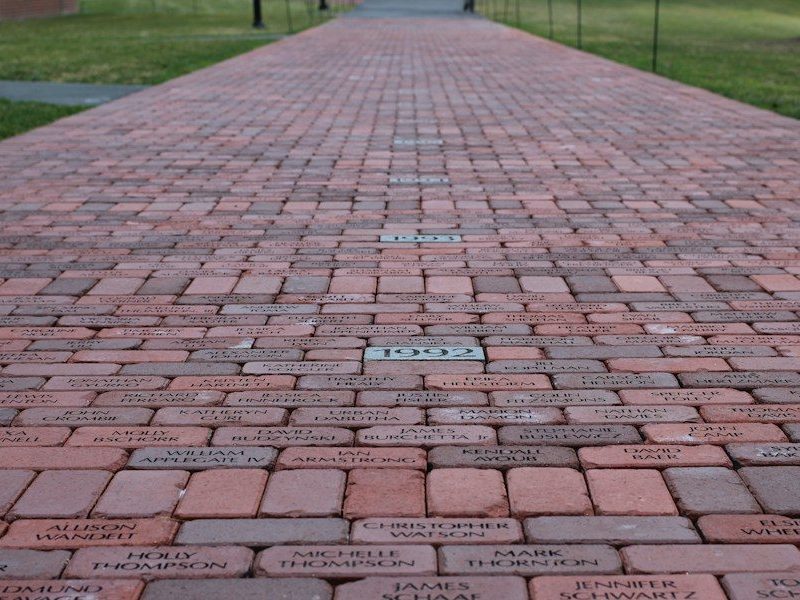 a brick walkway with names written on it