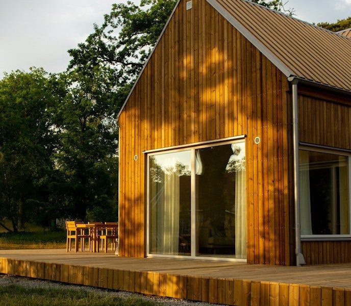 a wooden house with a deck and a patio