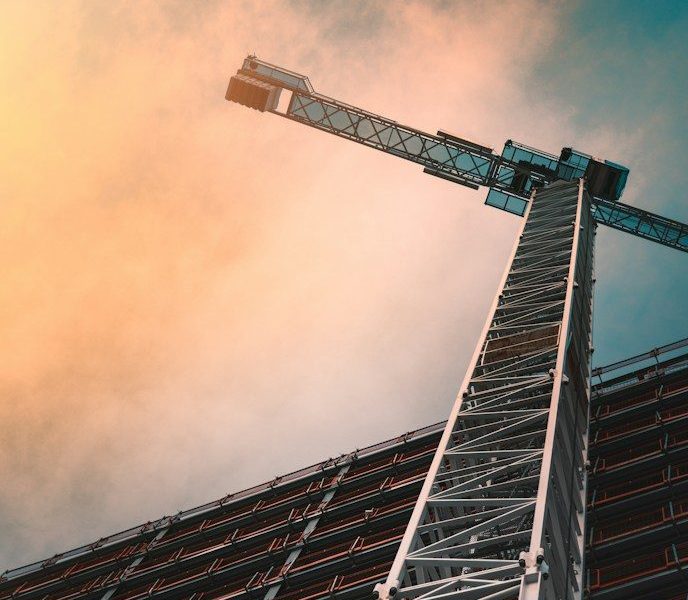 low angle photography of gray tower crane