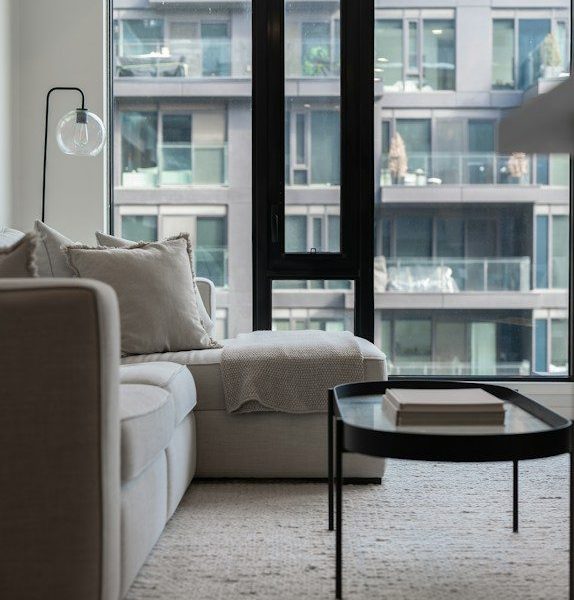 Modern living room with large window and city view