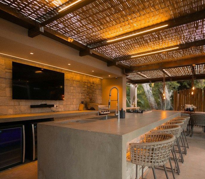 Modern outdoor kitchen with bar and seating