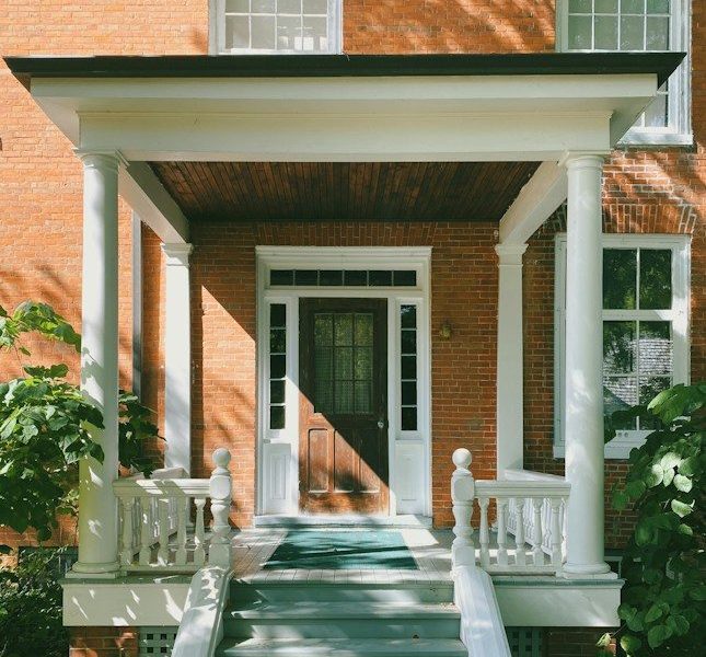 brown brick house with white wooden door